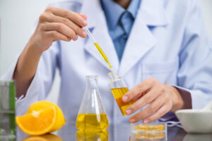a lab technician running tests to ensure citrus oil quality assurance