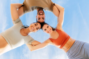 low angle view of three young people in fitness gear; happy and healthy